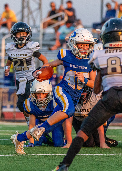 A Piedmont Youth football player running with the ball. 