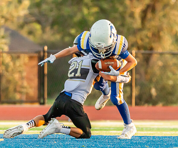 A Piedmont Youth football player getting tackled. 